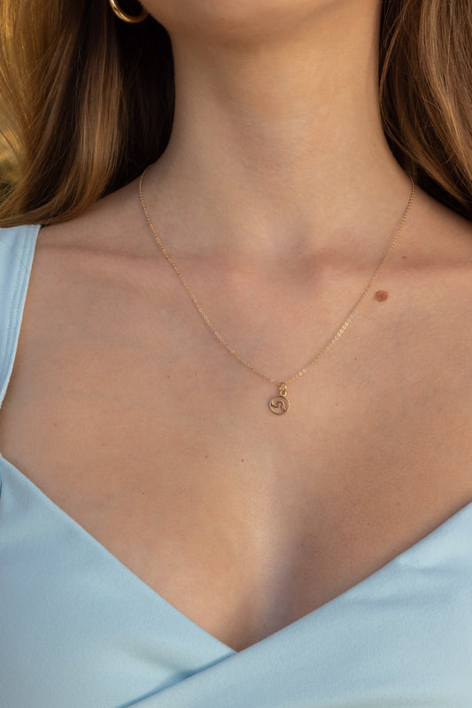 Gold filled wave necklace, close up view, displayed on neck